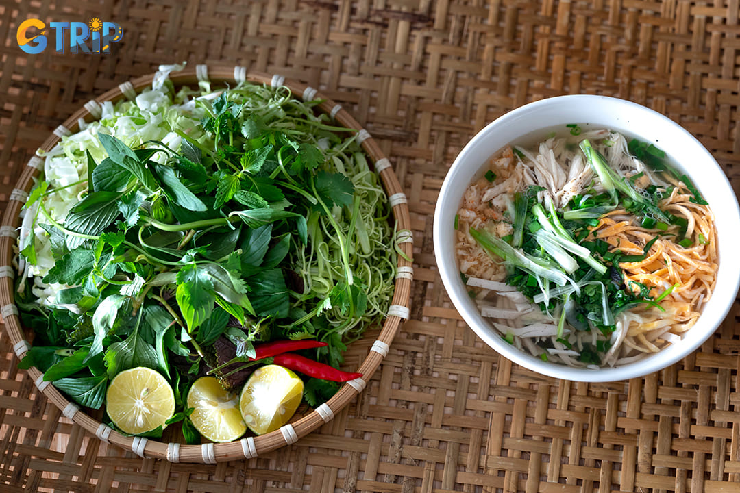Bun thang is Hanoi’s most refined noodle soup, featuring shredded chicken, fried egg, Vietnamese ham, and dried shrimp in a clear, delicately simmered broth