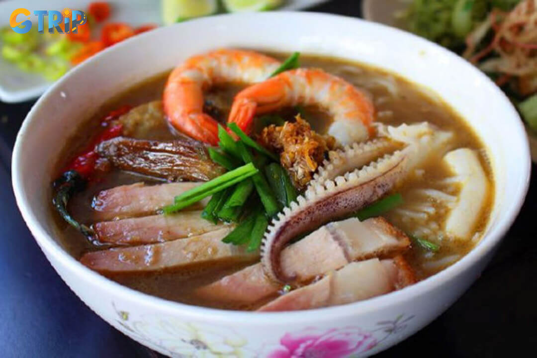 A hidden alleyway gem serving a sweet-savory Western-style bun mam packed with fresh toppings and home-style charm, perfect for those seeking an authentic local find