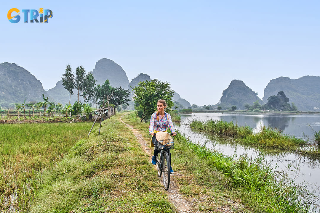 A tourist is cycling through rural villages with beautiful landscapes