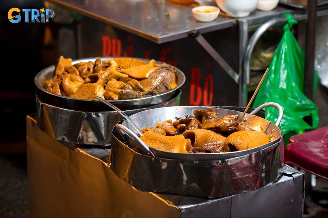 Alley 200 on Xom Chieu Street is a narrow, lively food alley packed with local stalls, famous for affordable street food and especially its rich coconut-milk pha lau