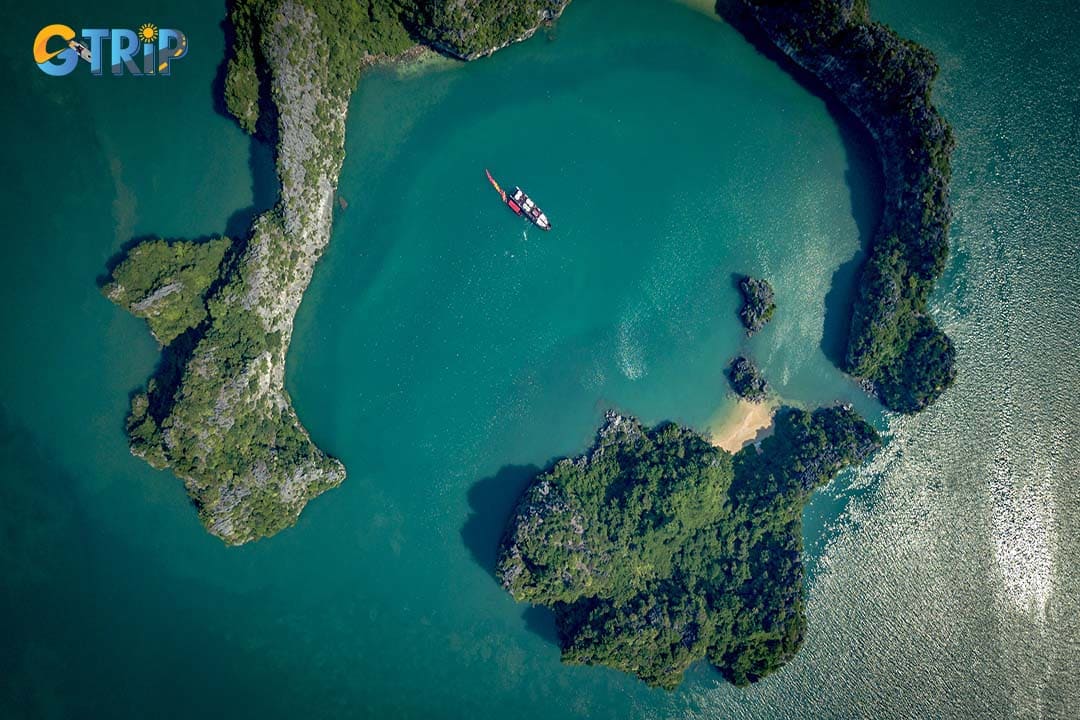 Bai Tu Long Bay offers tranquil beauty, secluded beaches, and crystal-clear waters, perfect for kayaking and peaceful boat tours