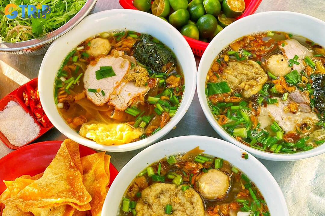 Banh da cua is a rich crab noodle soup with chewy brown noodles and a savory broth, offering a bold, flavorful start to Hanoi mornings