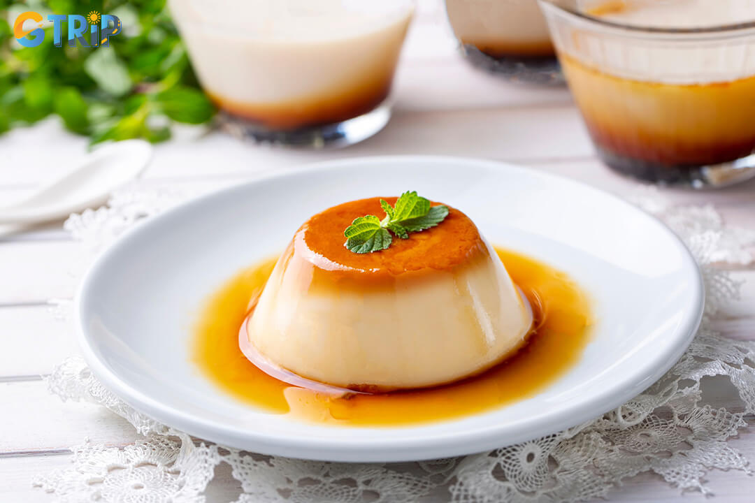 Banh flan is Vietnam’s silky custard dessert with rich caramel, often served chilled with coffee and crushed ice for a refreshing, sweet treat