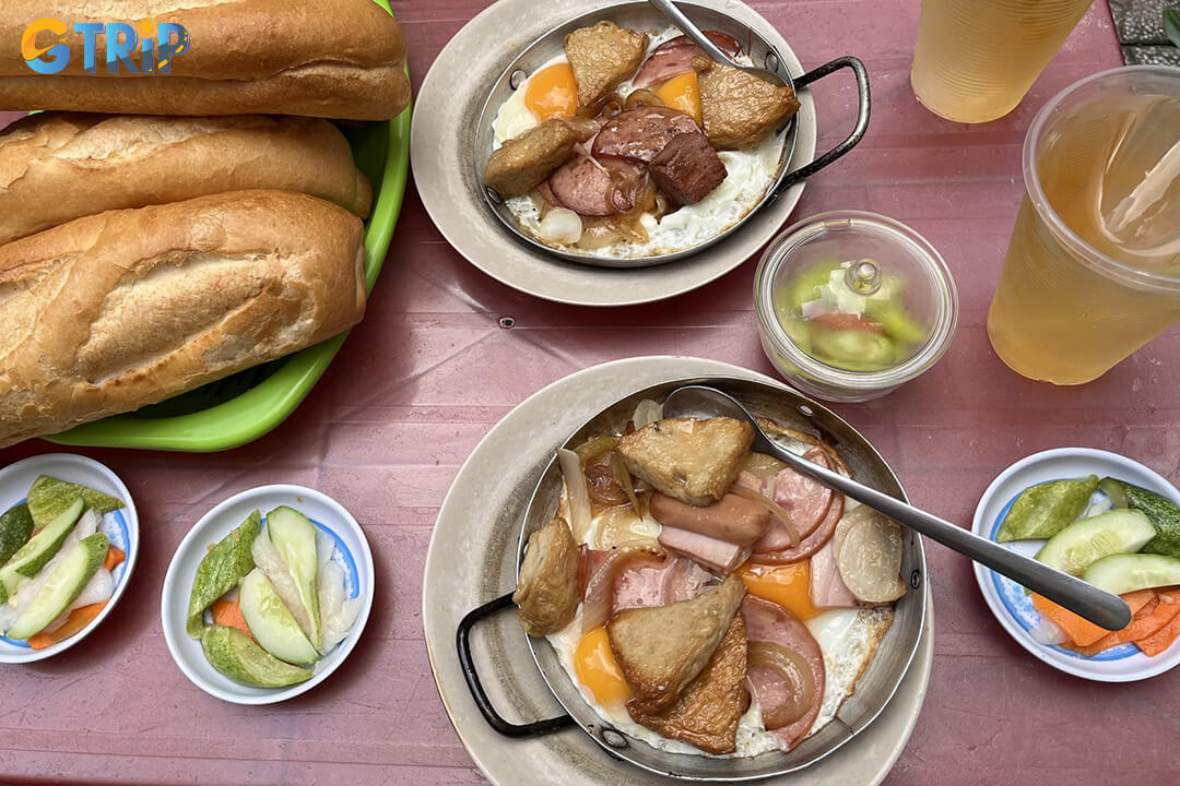 Banh Mi Hoa Ma serves a unique, interactive Vietnamese sandwich with sizzling eggs, savory cold cuts, and crispy baguettes for a memorable Saigon breakfast