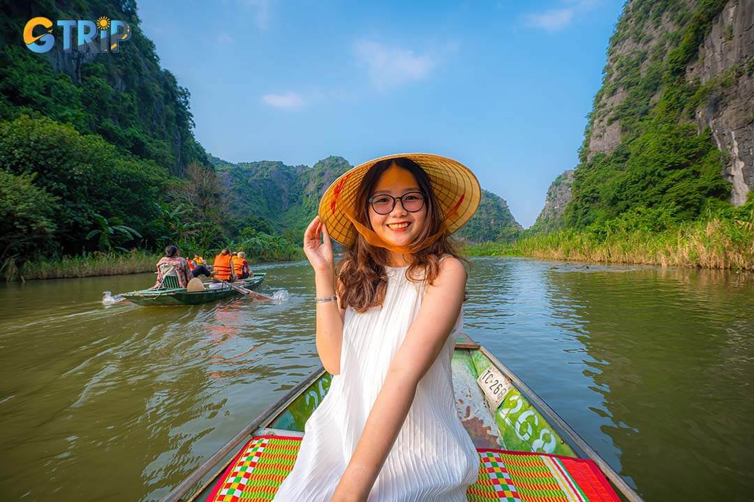 A lovely girl was on the boat as it drifted along the Ngo Dong River.