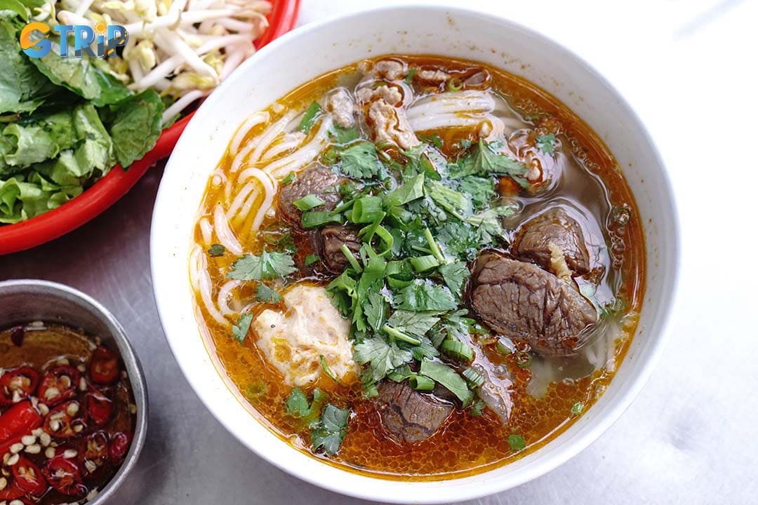 Bun Bo Hue is a bold, spicy noodle soup defined by its lemongrass- and shrimp-paste-infused broth, thick rice noodles, and hearty toppings