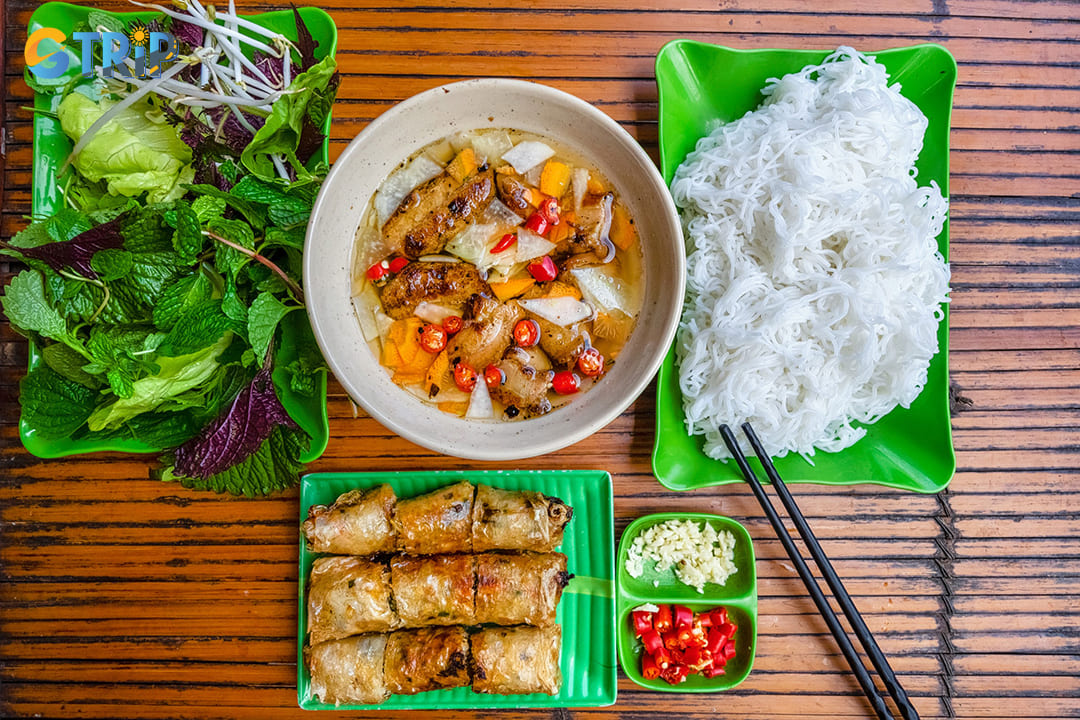 Bun cha, arguably Hanoi's most famous dish, consists of grilled pork served with rice vermicelli, fresh herbs, and a sweet-sour dipping sauce