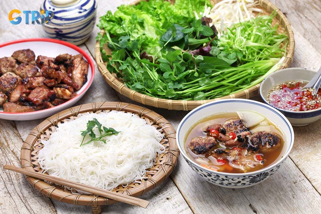 Bun cha is a Hanoi-born dish featuring grilled pork patties and sliced pork belly in a savory-sweet fish sauce broth, served with rice vermicelli and fresh herbs