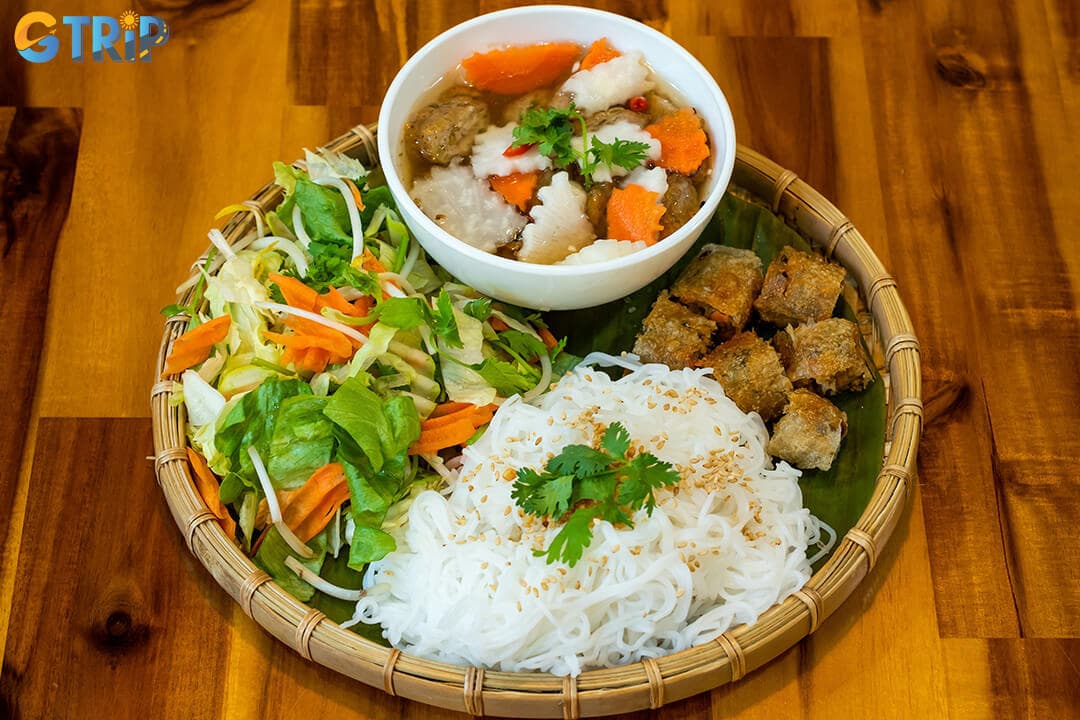 Bun cha is a Hanoi breakfast classic of grilled pork, vermicelli, and herbs, served with a tangy dipping sauce that captures the city's bold, balanced flavors