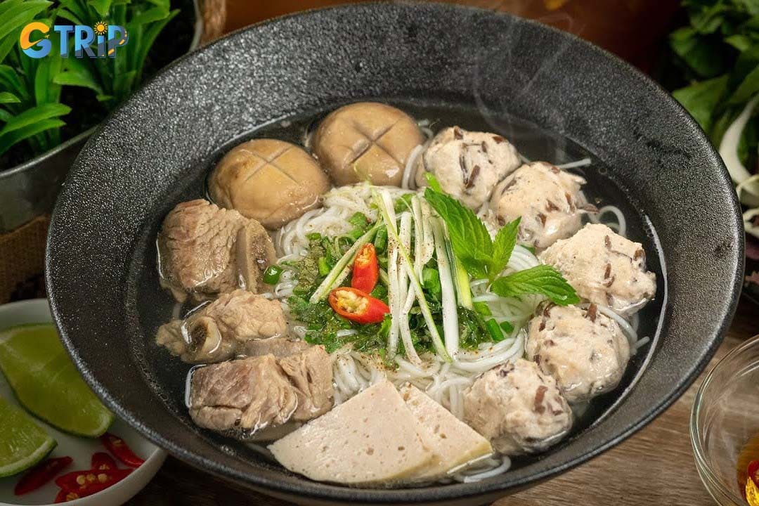 Bun Moc is a light, comforting noodle soup featuring a clear pork-and-mushroom broth, tender pork meatballs, and thin rice vermicelli