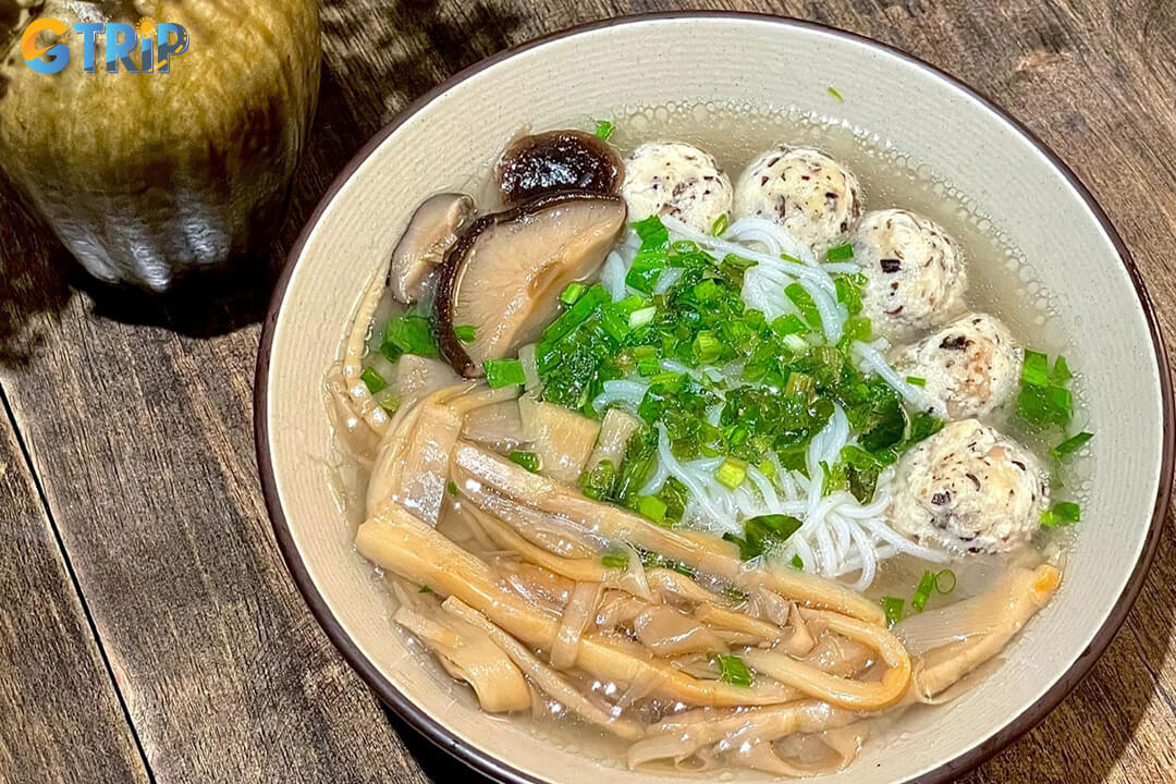 Bun moc is a light Hanoi-style breakfast soup with clear pork broth, vermicelli, pork and mushroom balls, fresh herbs, and a gentle, savory flavor