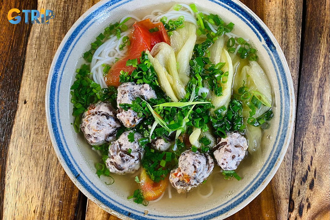 Bun moc offers a hearty, rustic flavor profile centered around handmade pork and mushroom meatballs