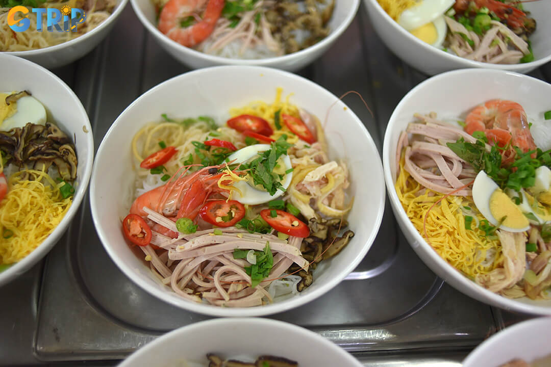 Bun thang is Hanoi’s most refined noodle soup, known for its clear broth, elegant presentation, and delicate balance of flavors
