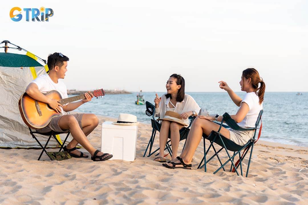 Playing guitar and singing with clap while picnic and camping on Son Hao Beach