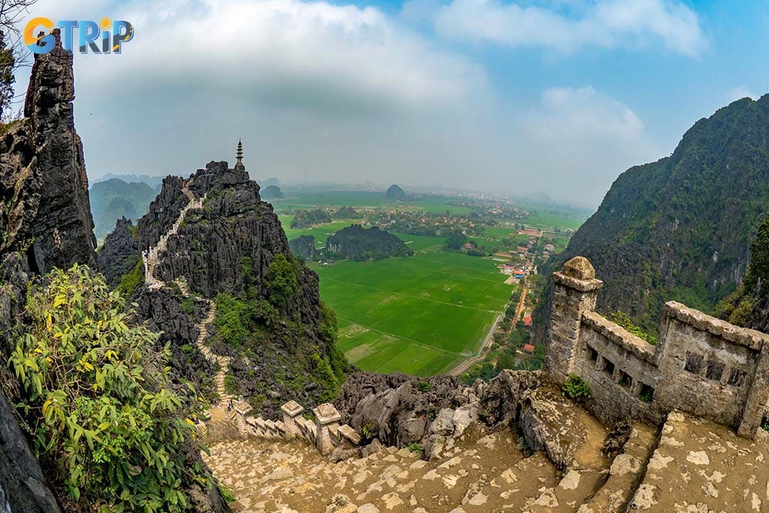 Climb 500 steps at Mua Cave for breathtaking views of Tam Coc and the iconic dragon statue atop Ngoa Long Mountain