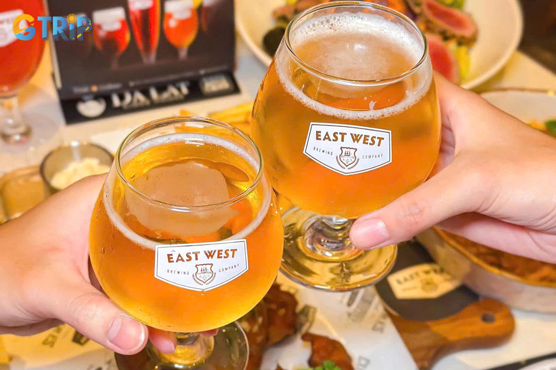 East West Brewing Saigon combines Western brewing techniques with Eastern flavors, offering a diverse beer selection, rooftop terrace, and a full menu