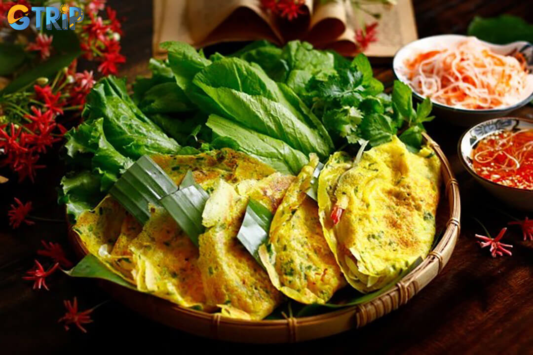 Eating Banh Xeo is a hands-on experience break off a piece, wrap it with herbs (and rice paper), roll it up, and dip it into the sauce for the perfect bite