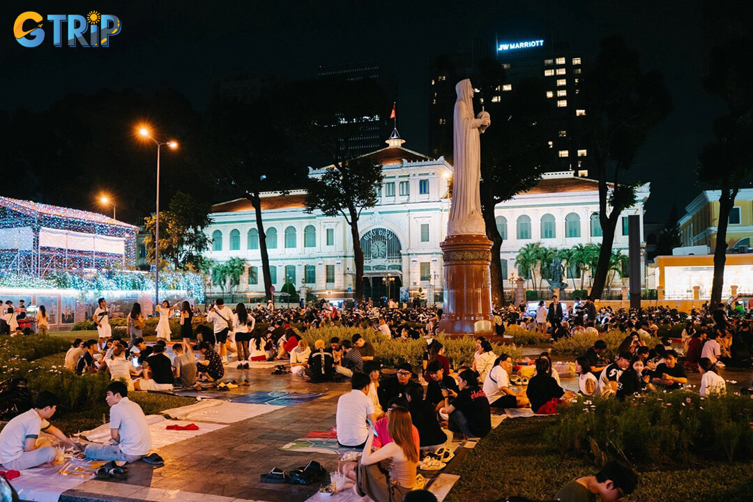 Enjoying sidewalk coffee near Notre Dame Cathedral offers a quintessential Saigon experience, blending historic grandeur with lively street culture and casual evening vibes