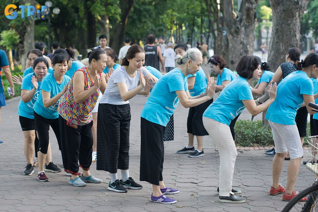 Experience Hanoi’s peaceful side at dawn with a walk around Hoan Kiem Lake, where locals gather for Tai Chi, dancing, and lakeside coffee as the city slowly awakens
