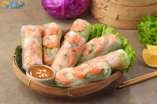 Goi cuon are fresh rice paper rolls with noodles, herbs, and proteins like shrimp or pork, served with a savory peanut-hoisin dipping sauce