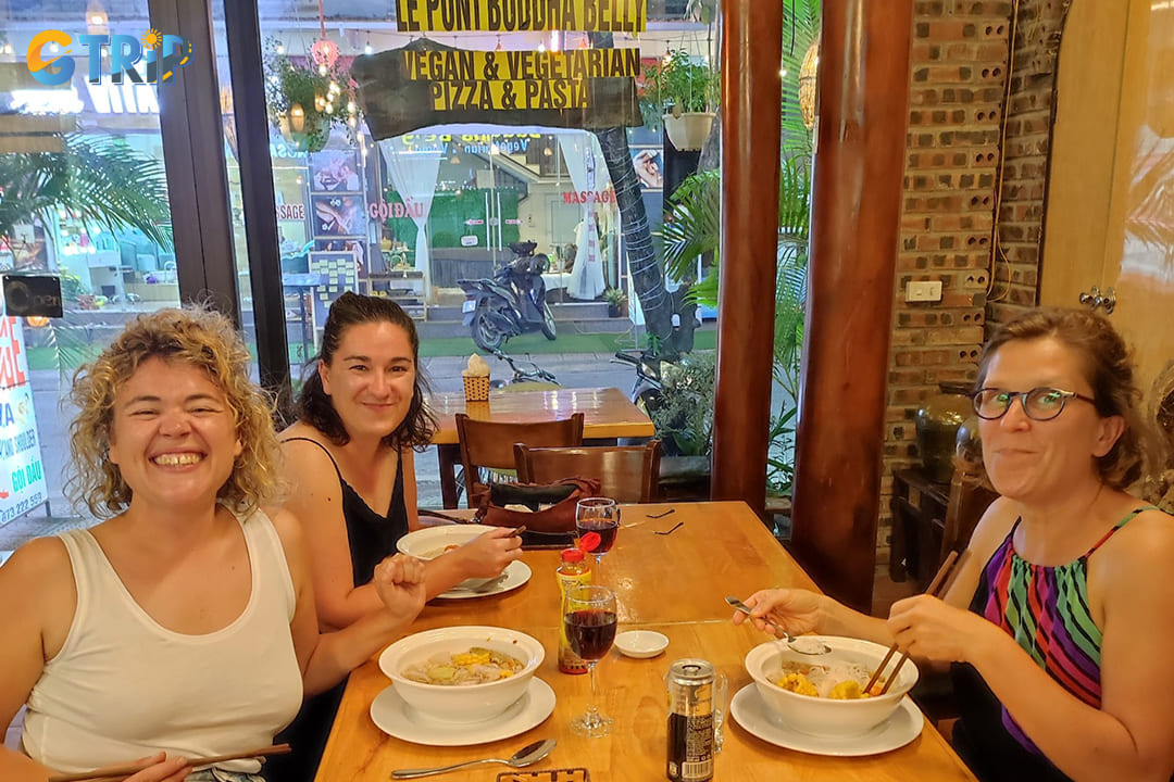 Happy tourists are having meals at the restaurant