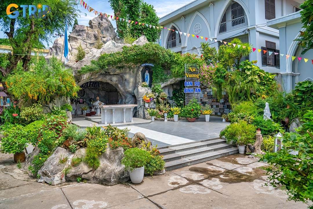 Hidden behind the main church, the Lourdes-style Marian grotto offers a quiet, leafy retreat where visitors can pause for prayer, reflection