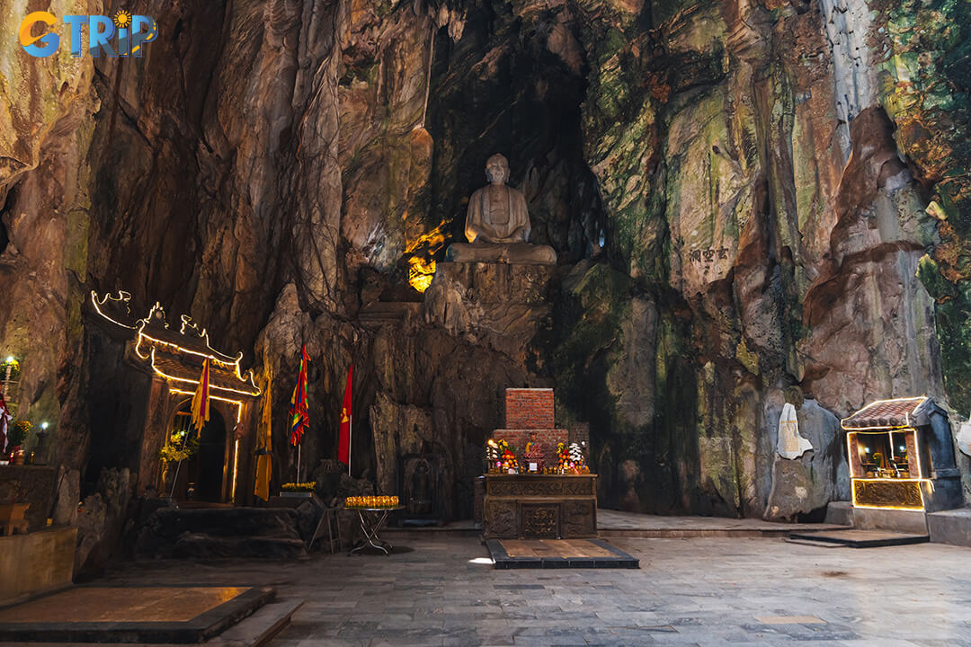 Huyen Khong Cave is famed for its dramatic sunlit ceiling, serene Buddha statue, and profound blend of natural beauty, spirituality, and wartime history