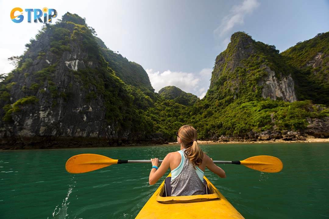 Tourist exploring Ha Long Bay by kayak