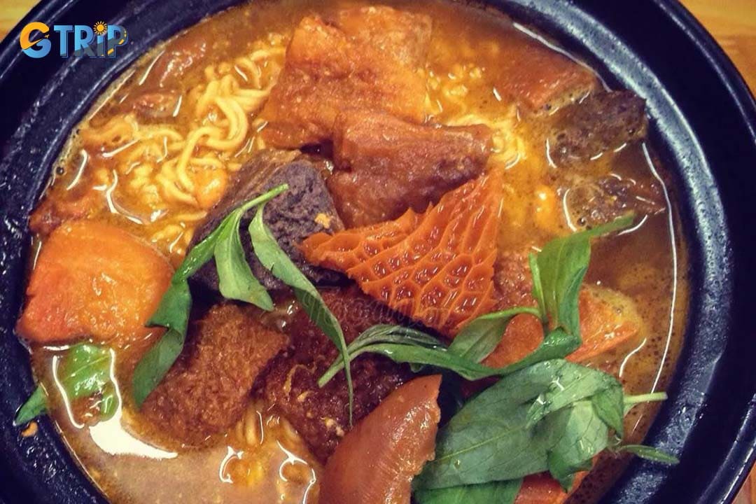 Mi Pha Lau is a bold Saigon favorite featuring chewy egg noodles topped with tender pork or beef offal braised in a rich, slightly sweet coconut-and–five-spice broth