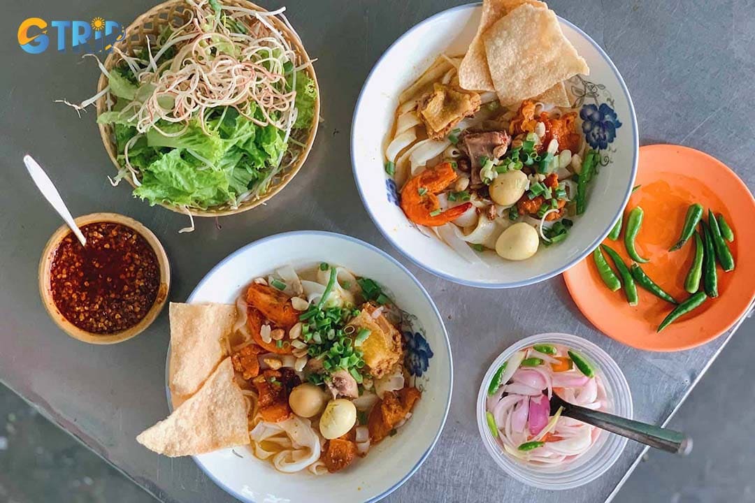 Mi Quang Ba Dinh is a local gem known for its lighter, clearer broth and customizable bowls topped with shrimp, pork, chicken, and eggs
