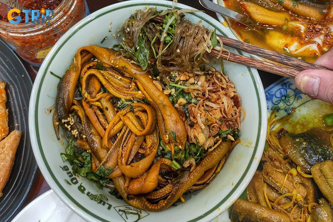 Mien luon is a uniquely Hanoian delicacy featuring glass noodles topped with crispy fried eel, fresh herbs, bean sprouts, and a savory broth