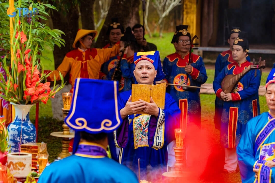 Performers in traditional royal attire stand in front of The To Mieu to begin the Thuong Tieu ceremony