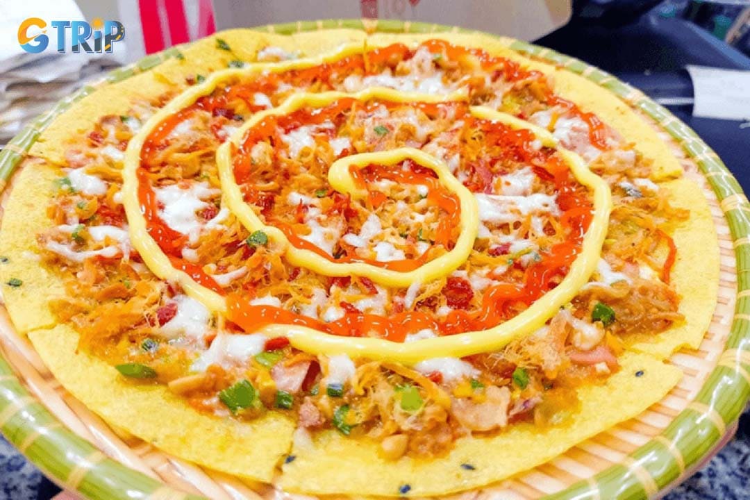 Pham The Hien Street is a lively local food strip known for cheap snacks like banh trang nuong (grilled rice paper) and fried skewers