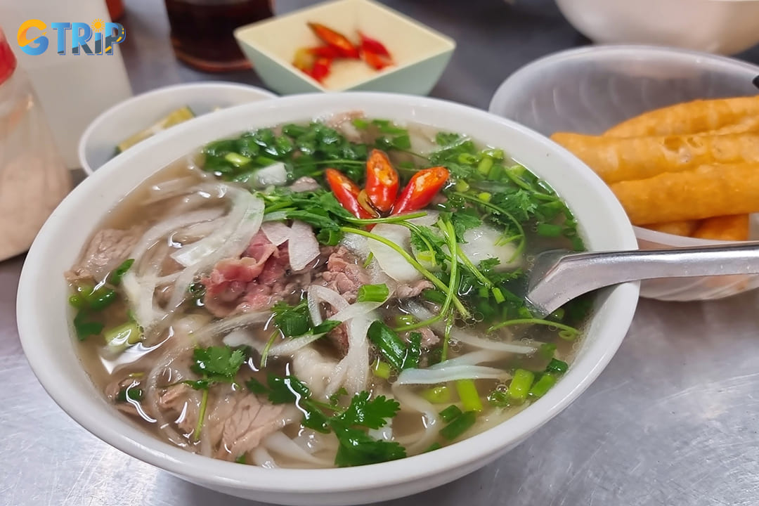 Pho Bo Phu Xuan stands as one of Hanoi's most respected establishments for authentic beef pho, distinguished by its remarkably rich and aromatic broth