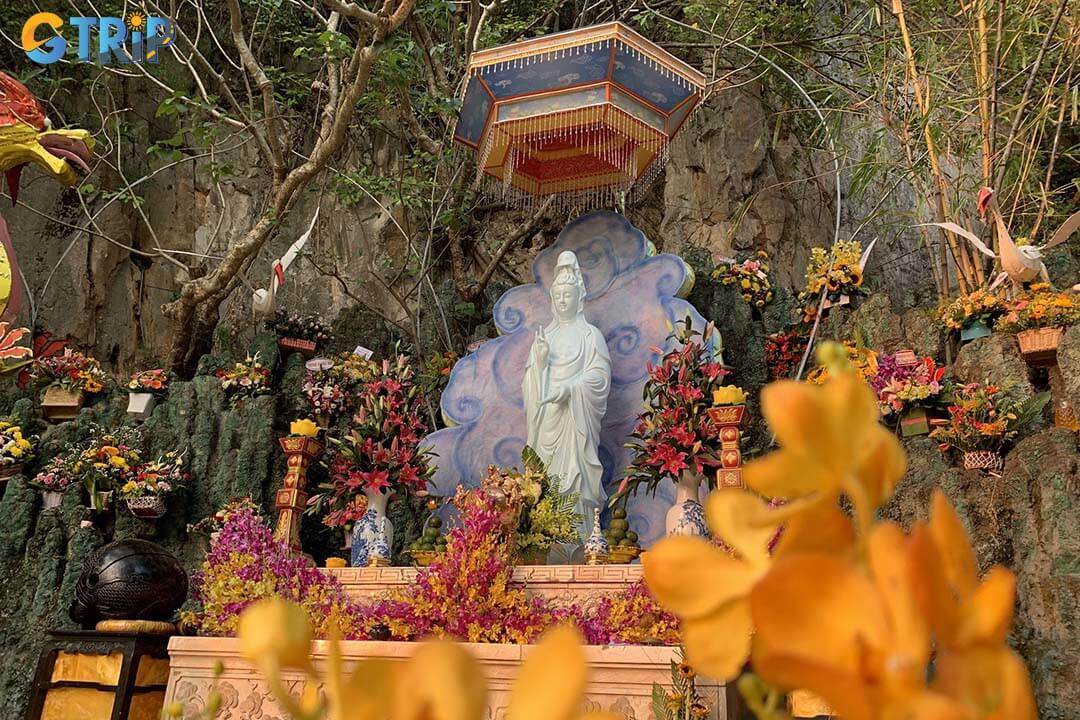 Quan The Am Pagoda seamlessly combines traditional temple design with its cliffside setting, leading visitors from peaceful courtyards into the sacred Hoa Nghiem Cave