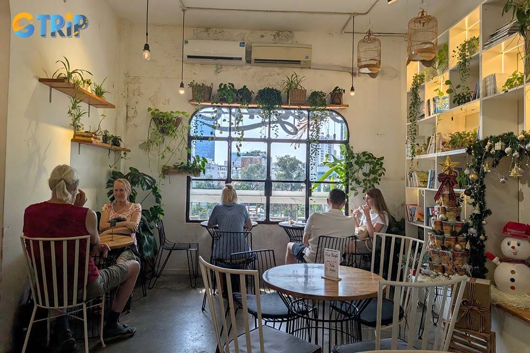 Saigon Oi is an elegant cafe with a large balcony, wooden floors, and hanging lanterns