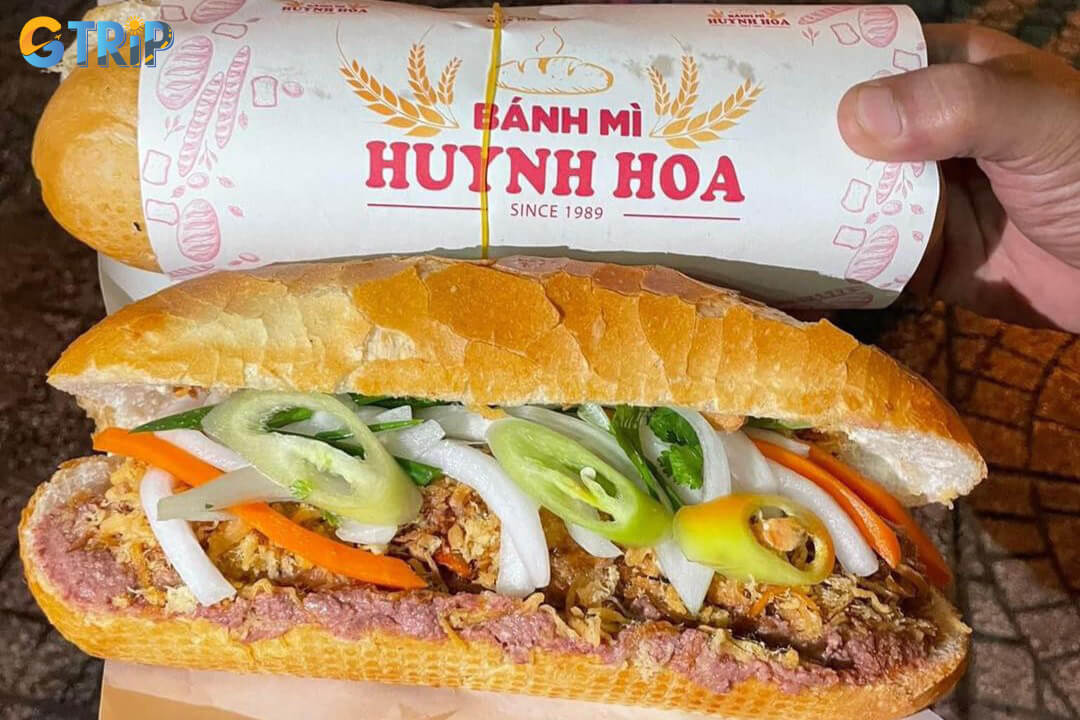 Saigon’s Banh Mi is a crispy baguette filled with savory meats, pate, pickled vegetables, fresh herbs, and chili for a flavorful, iconic street food experience