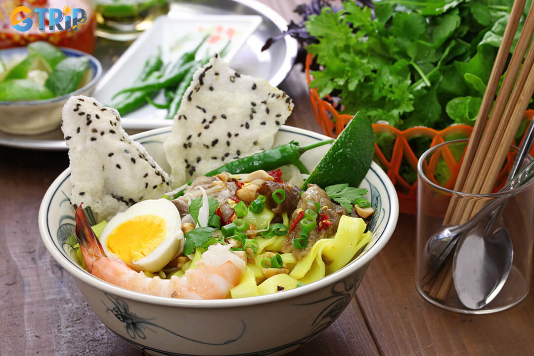 Savor Quang Nam’s signature flavors with specialties like Mi Quang and traditional rice cakes