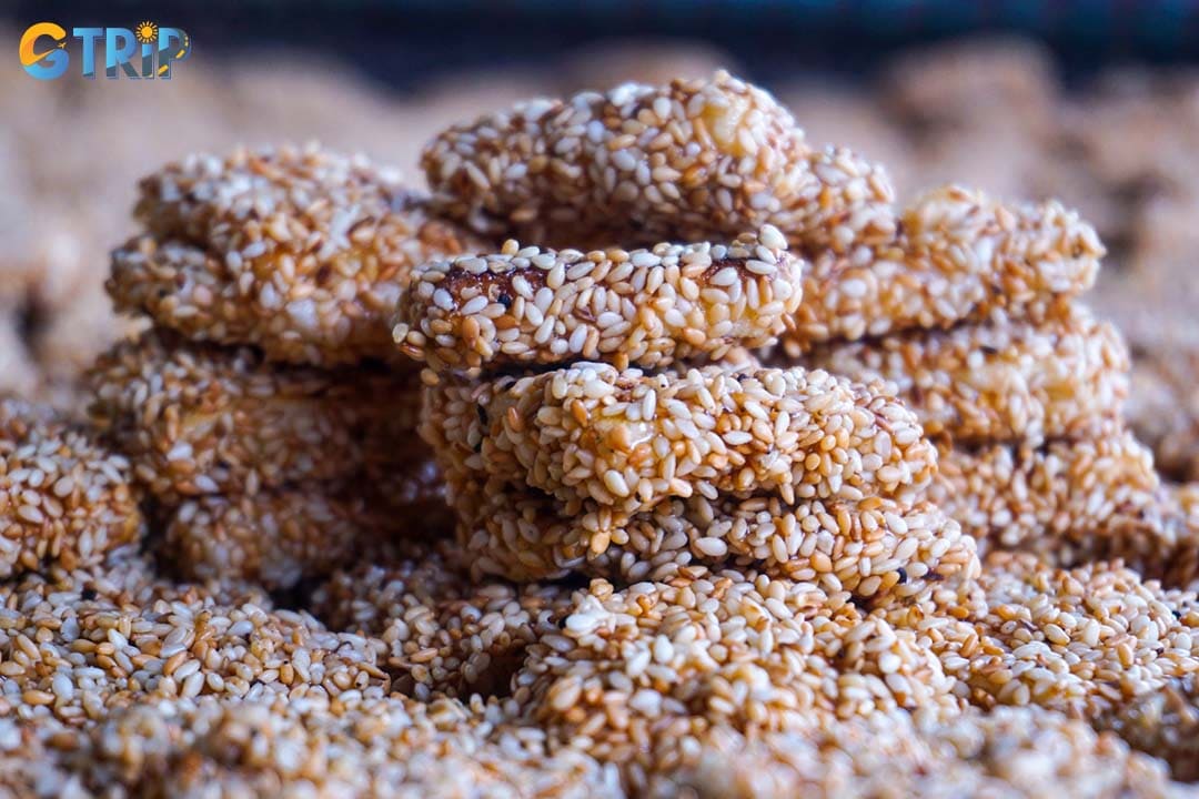 Sesame crackers (banh kho me) are handmade from sesame, rice flour, sugar, and ginger with a crispy texture and a warm spicy-sweet flavor