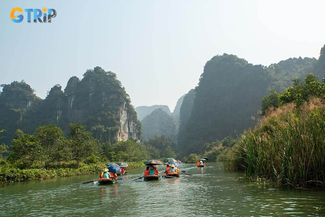 Start your day with a boat tour of Trang An, a UNESCO site featuring caves, temples, and towering limestone mountains in a serene setting