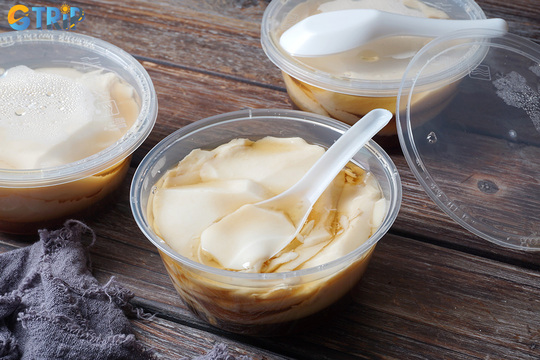 Tau pho is a silky tofu pudding served with fragrant ginger syrup, offering a light, comforting, and nostalgic Hanoi street dessert