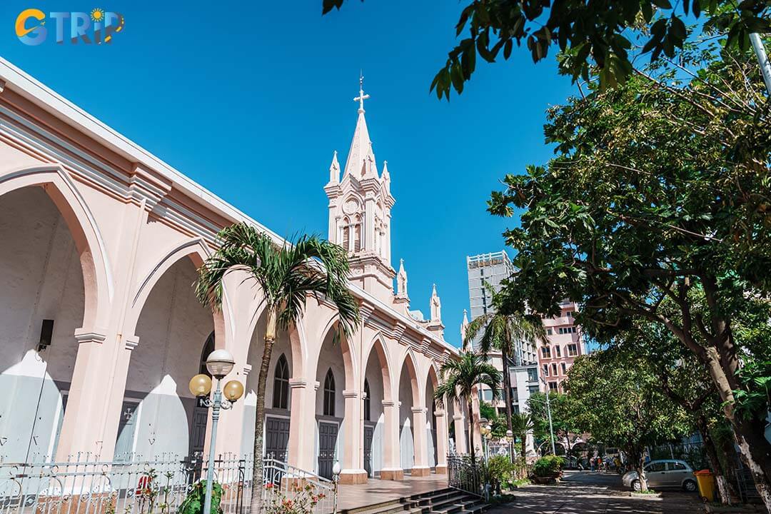 The cathedral’s exterior showcases elegant French Gothic details beautifully contrasted by its iconic pink hue