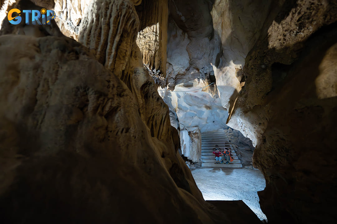 The cave reveals its captivating stalactites and stalagmites