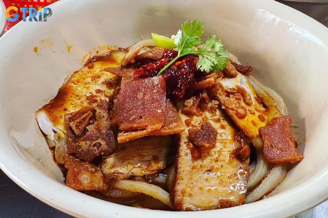 The defining feature of Cao Lau Lien is its incredibly rich and flavorful pork