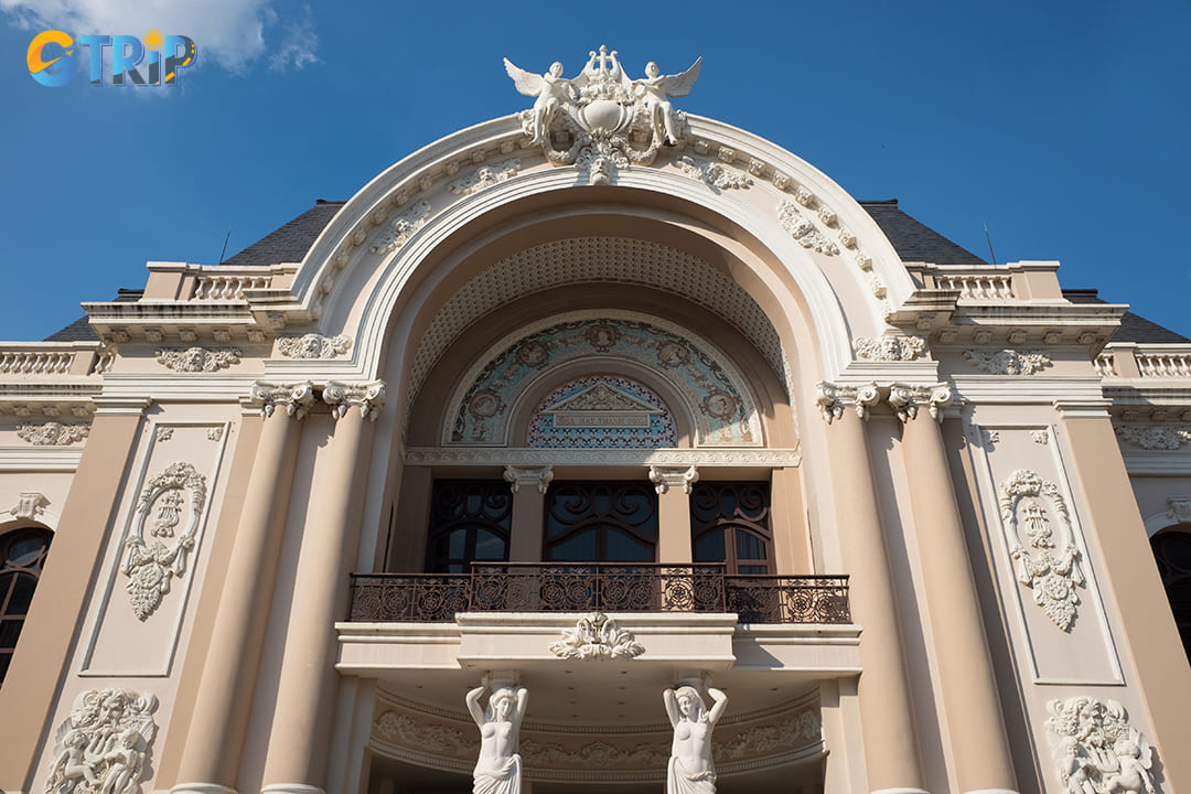 The exterior is adorned with intricate bas-reliefs, sculpted motifs, and decorative stonework
