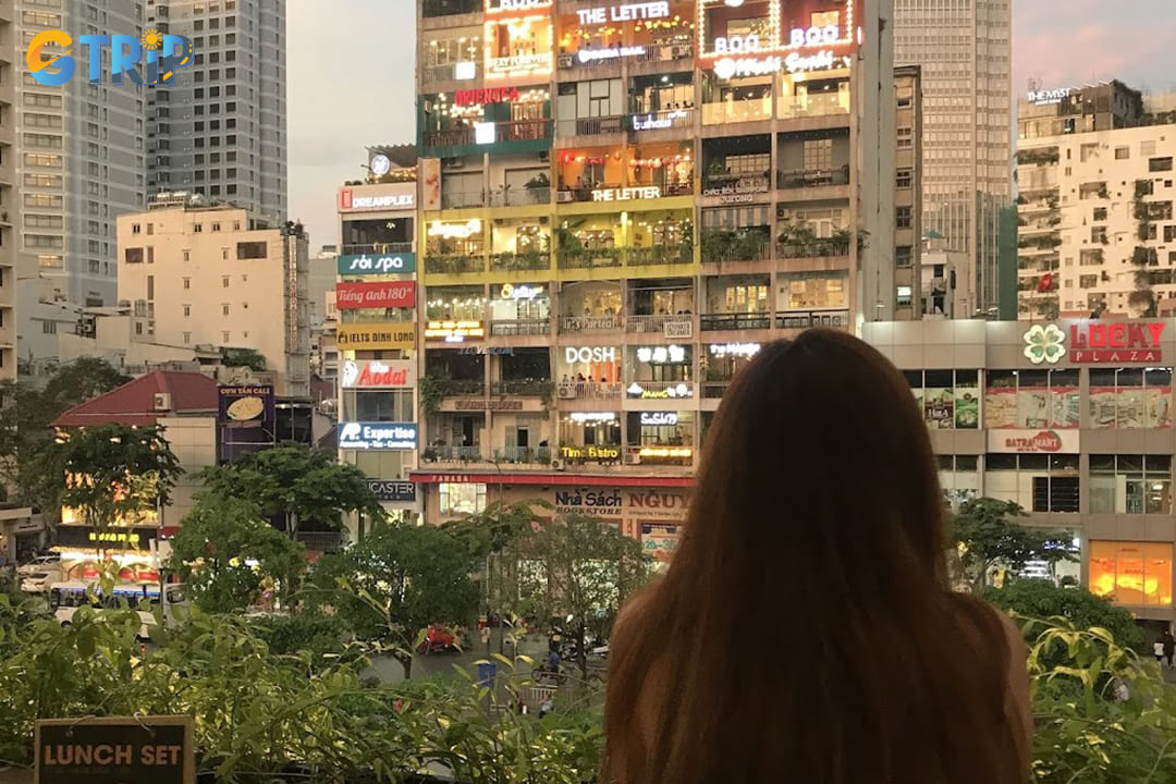 The large windows and balcony provide a picturesque view of Nguyen Hue Walking Street