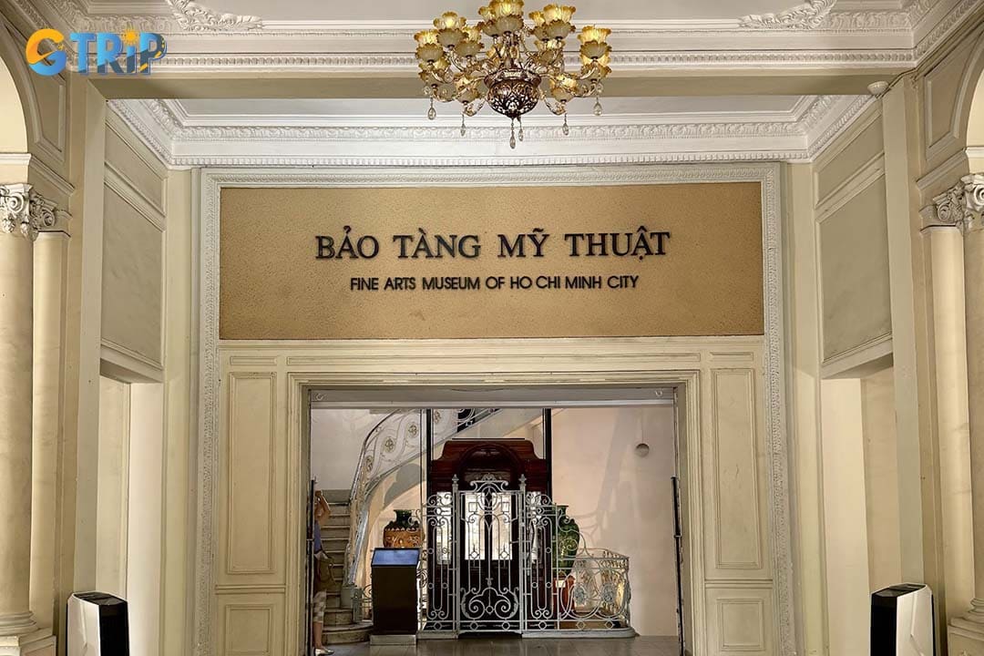 The main entrance greets visitors with an ornate wrought-iron gate and a graceful portico that lead into the building’s storied interior