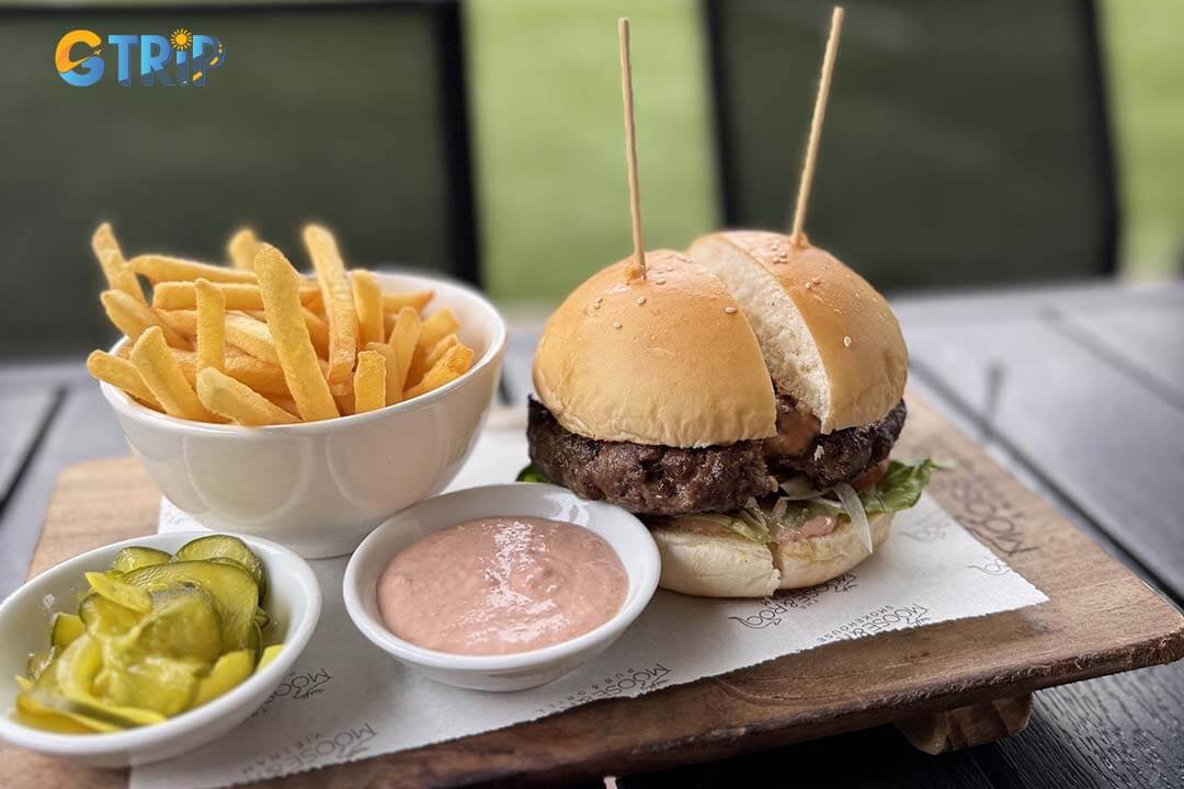 The Moose & Roo Smokehouse offers American barbecue with smoked meats, burgers, and drinks in a family-friendly, rustic setting at Hanoi's American Club