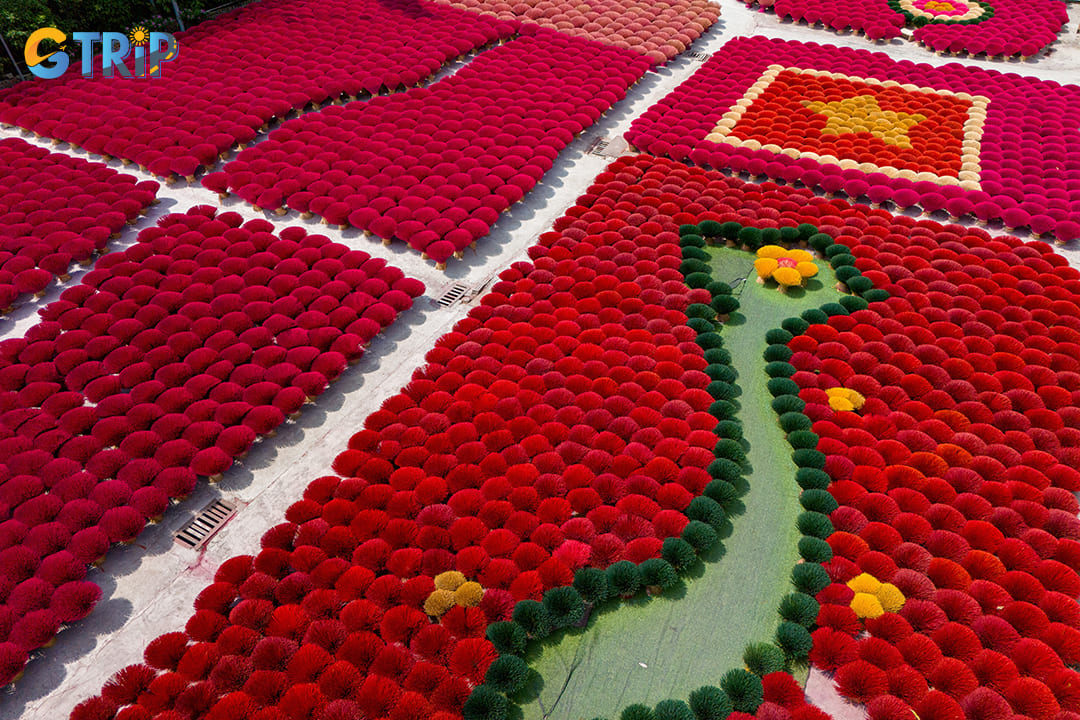 The most visually stunning aspect of Quang Phu Cau is its expansive drying fields, where thousands of freshly-made incense sticks create a breathtaking crimson landscape