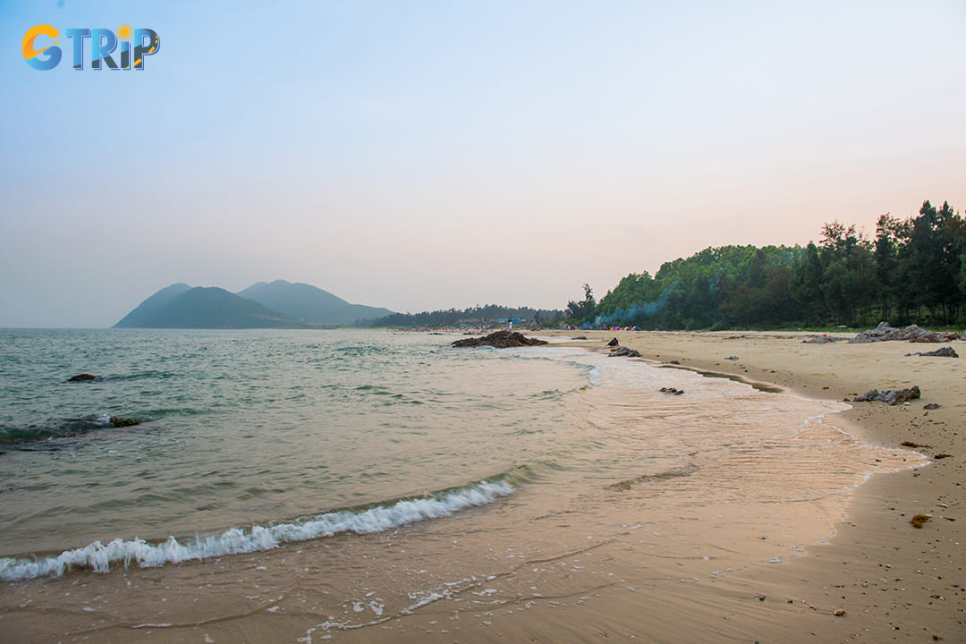 The pristine stretch of fine white sand, calm turquoise waters, and the tranquil atmosphere of Quan Lan Beach